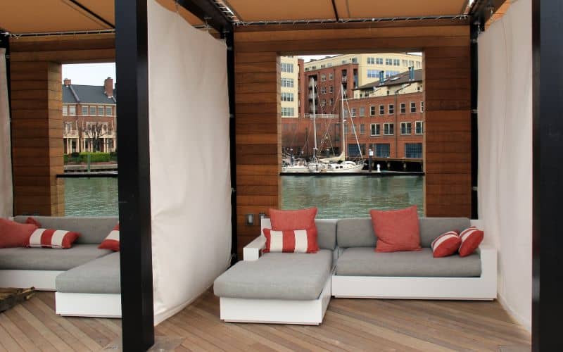 Corner-couches-for-sale-gorgeous-sitting-area-tucked-into-outside-corner-of-pool-area-sagamore-pendry-hotel-baltimore-maryland-min