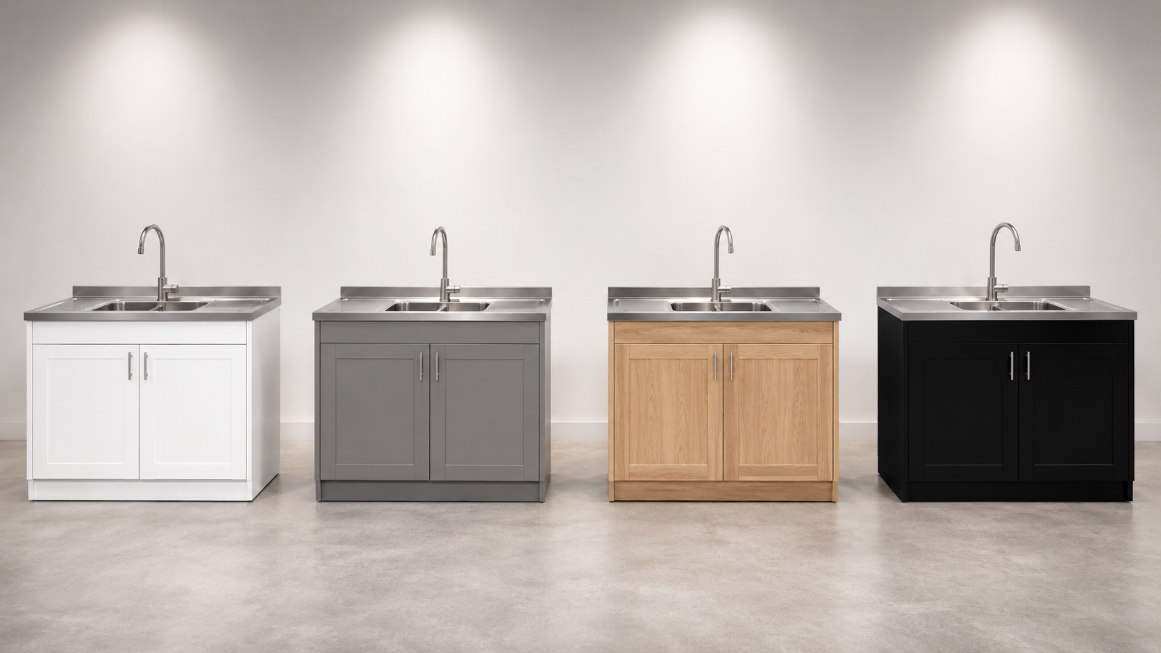 Kitchen sink cupboards in different finishes with integrated stainless steel sinks displayed in showroom